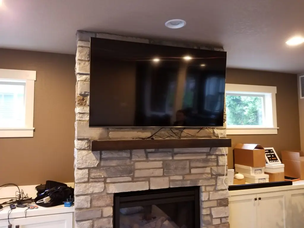 TV mounted above fireplace in Beaverton Oregon